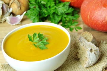 Creamy pumpkin soup. Ingredients for cooking on background.