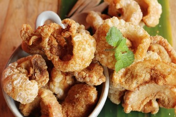 Fried pork skin is delicious on wood background