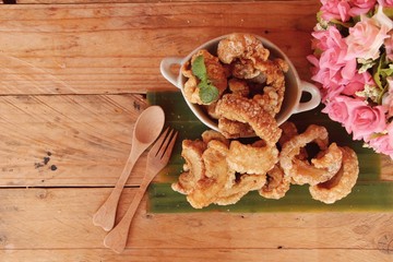 Fried pork skin is delicious on wood background