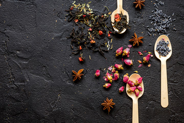 Herbs on spoons black background mock-up top view