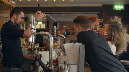 Bartender Giving Cocktail Making Demonstration In Bar