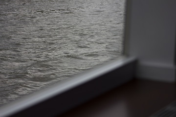 the view from the cabin window of the ship on the river