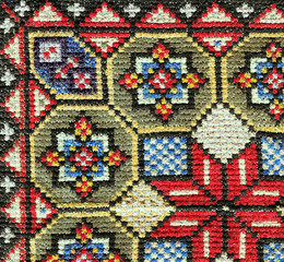Cross stitch embroidery. Close-up geometric colorful stitch ornament
