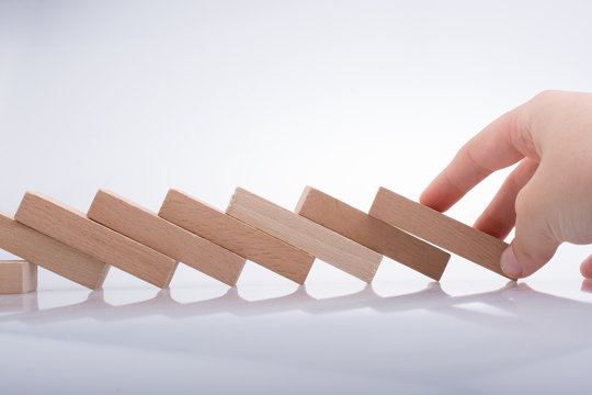 Hand holding wooden domino
