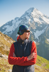 Fototapeta na wymiar Tourist woman hiker on the mountains background