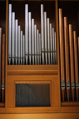 Copper and silver organ pipes in the Catholic basilica. Lecce, Italy.