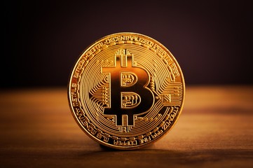gold bitcoin on wood surface