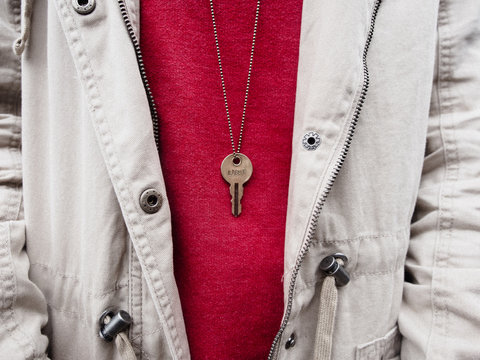 Close up of key necklace with word light"""lose u"
