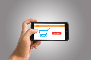 Online shopping sceen on phone background. Smartphone with cart.