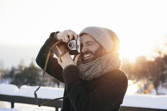 Stylish bearded man with film camera
