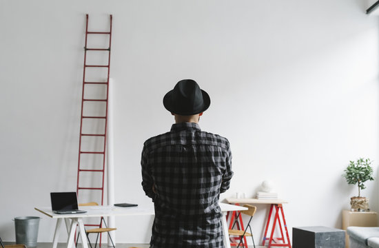 Man with hat in the office