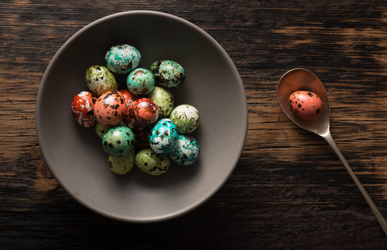 Colored Quail Eggs For Easter on Rustic Table
