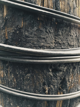 Close up of electrical wire around telephone pole