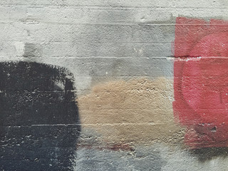 Paint covering graffiti marking on building wall, close up