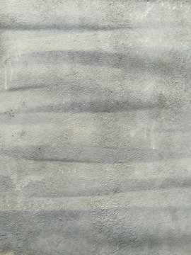 Close up of paint covering graffiti markings on concrete wall