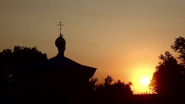 Silhouette of the church building at sunset