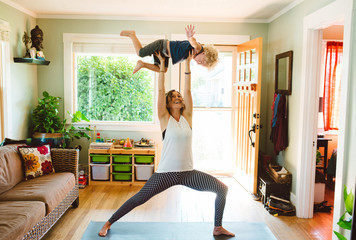 Super mom doing yoga with son