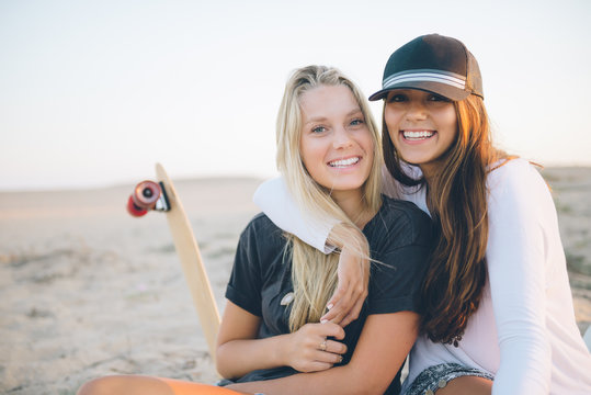 Two SoCal friends hanging out and sitting on the beach.