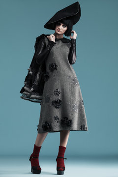 model wearing haute couture dresses on blue background