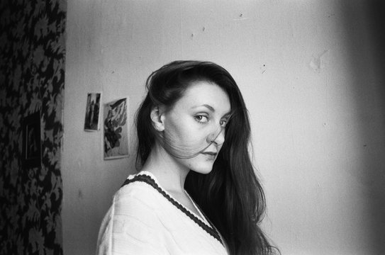 A black and white film photo of a young beautiful woman