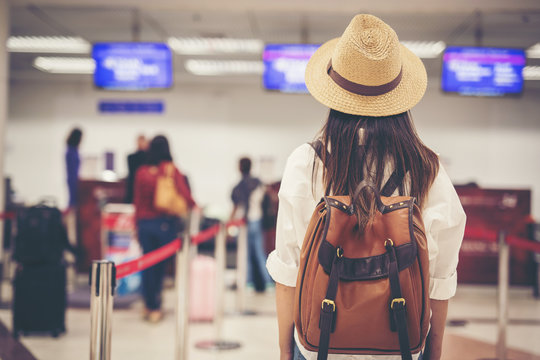 Happy woman tourist atin the airport.Travel concept.