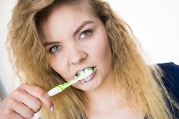 Woman brushing cleaning teeth