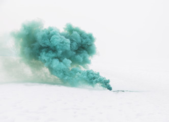 green smoke on the white snow