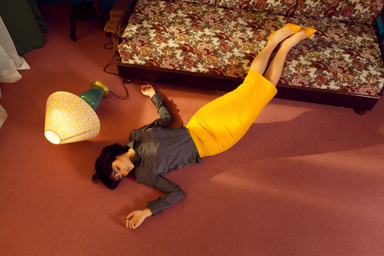 depressed young woman lies down on the floor