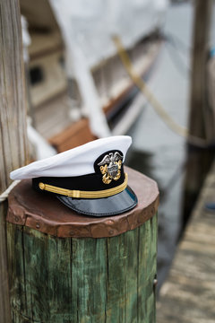 Military naval officer's lid on pier piling - vertical