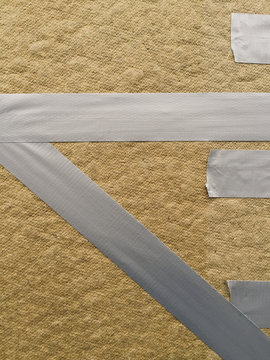 Duct tape across wood panel, covering broken shop window