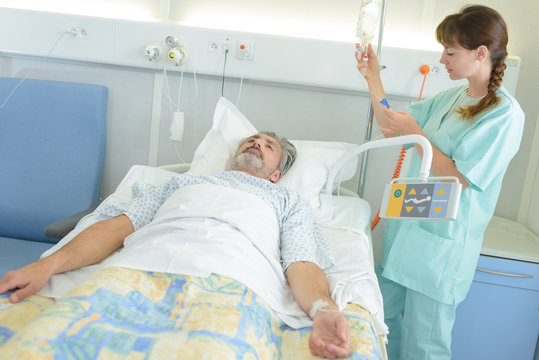 doctor or nurse talking to patient in hospital