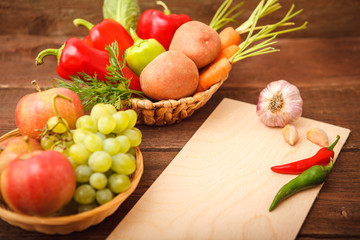 Freshly picked vegetables and fruits in a wooden background basket. Background. Autumn, harvest. Thanksgiving Day. Space for text.