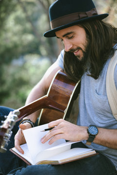 Talented young musician writing lyrics for his next song