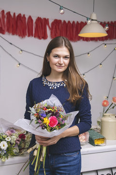 Portrait of female florist with beautiful bouquet