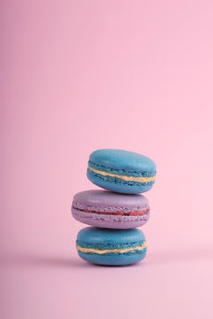 Delicious colorful macaroons on a pink background