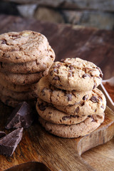 Chocolate cookies on wooden table. Chocolate chip cookies shot