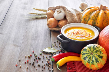 Pumpkin, carrot and ginger creme soup in ceramic pan