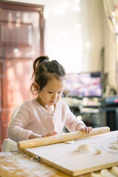 Toddler kid making Chinese Dumplings