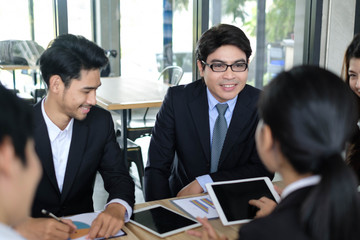 Asian business people meeting time,manager listening his staff brainstorming discussing about new startup project together in conference room at office,business colleagues teamwork concept