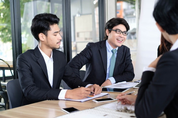 Asian business people meeting time,manager listening his staff brainstorming discussing about new startup project together in conference room at office,business colleagues teamwork concept