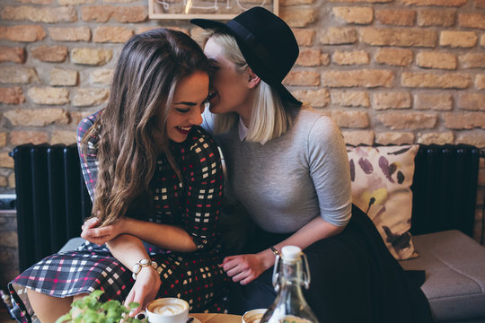 Two female friends drinking coffee