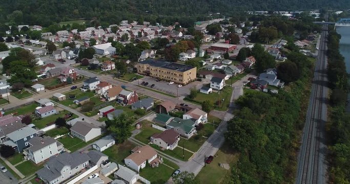 A slowly moving dolly forward aerial establishing shot of a typical Western Pennsylvania residential neighborhood in the late summer. Pittsburgh suburbs.  	