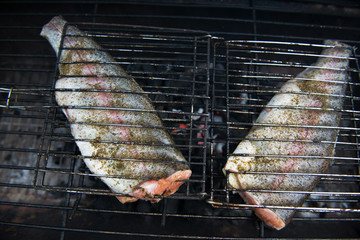 Raw trout fish on the grill.