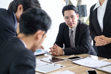 Asian business people meeting time,manager listening his staff brainstorming discussing about new startup project together in conference room at office,business colleagues teamwork concept