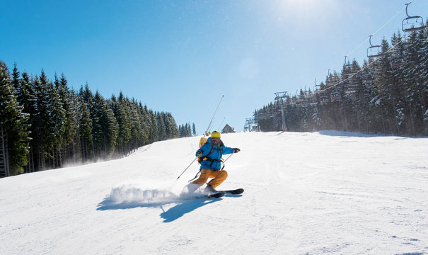 Professional skier riding down the hill enjoying skiing in the mountains outdoors sport recreation extreme lifestyle people travelling resort concept