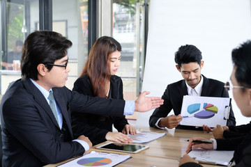 Asian business people meeting time,manager listening his staff brainstorming discussing about new startup project together in conference room at office,business colleagues teamwork concept