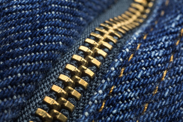 Macro showing teeth of a zipper on a pair of jeans
