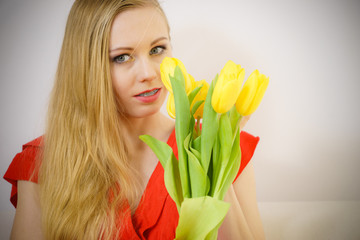 Lovely woman with yellow tulips bunch
