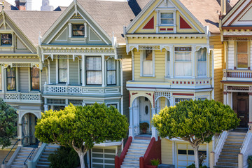 Beautiful view of Painted Ladies, colorful Victorian houses located near scenic Alamo Square in a row, on a summer day with blue sky, San Francisco, California, USA