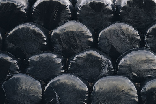 Detail of a stack of black wrapped bales on a farm. Derbyshire, UK.